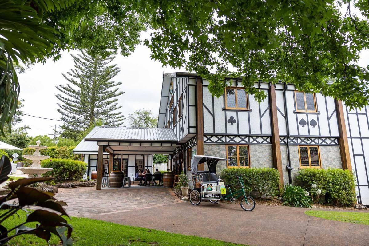 external shot of the distillery with unique design features set amongst a green gardens