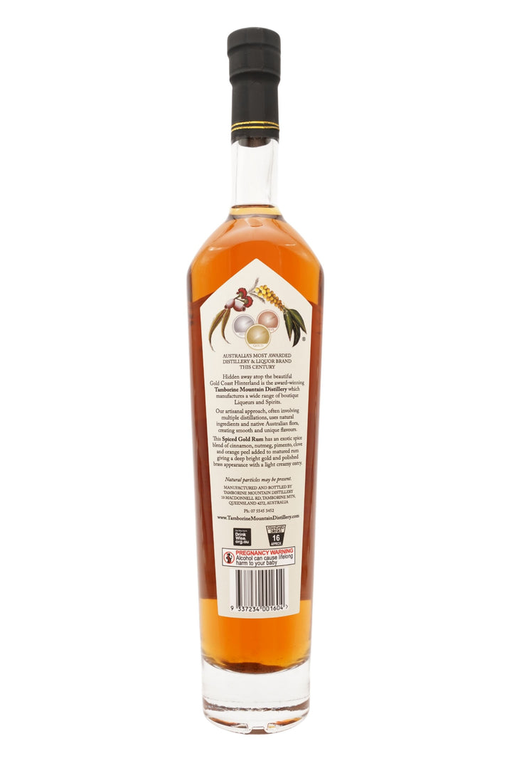 Back of 500ml clear glass bottle of Tamborine Mountain Distillery Spiced Gold Rum, featuring a watercolour-style illustrated label reflecting its flavour profile.
