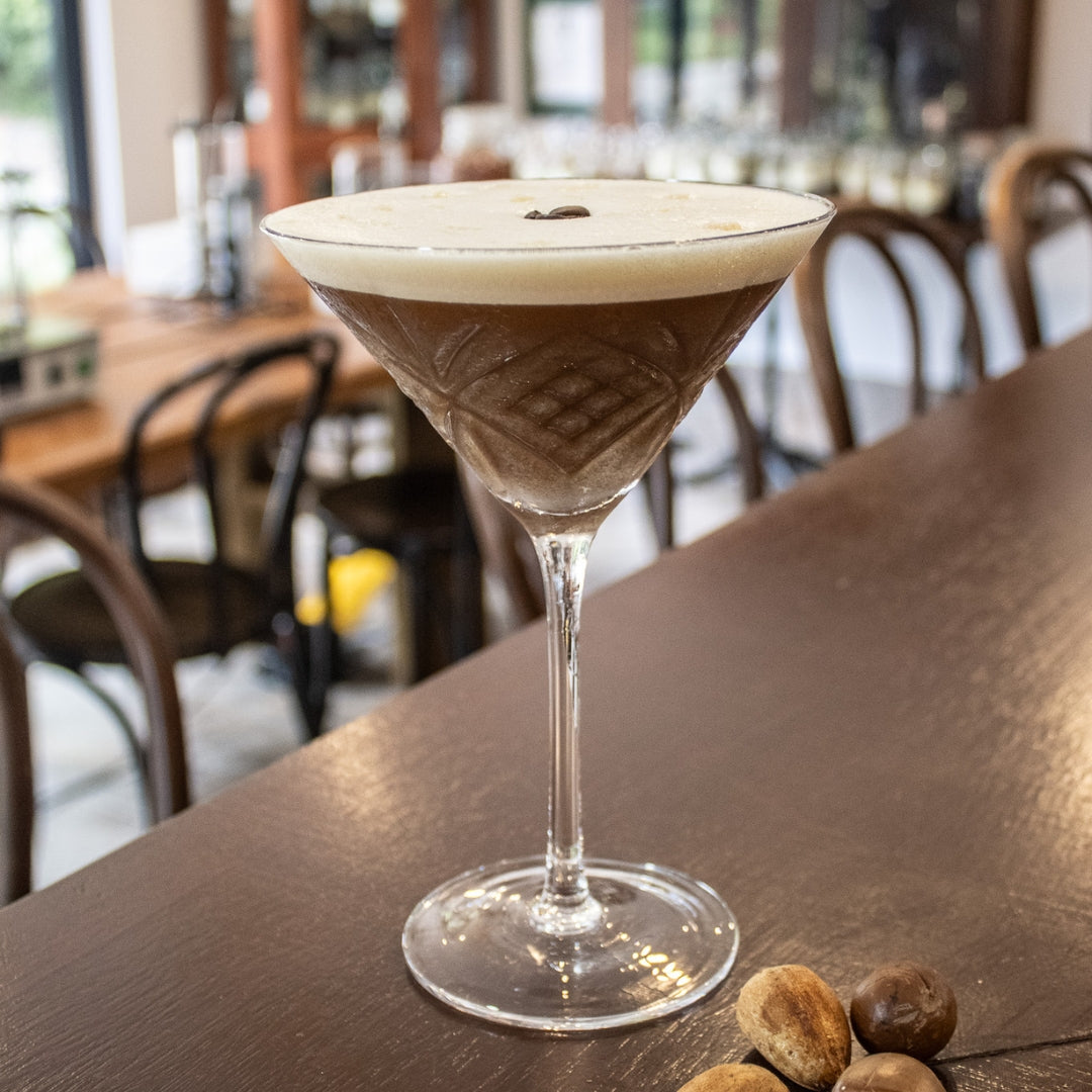 Nutty Espresso Martini with coffee beans and macadamia nuts