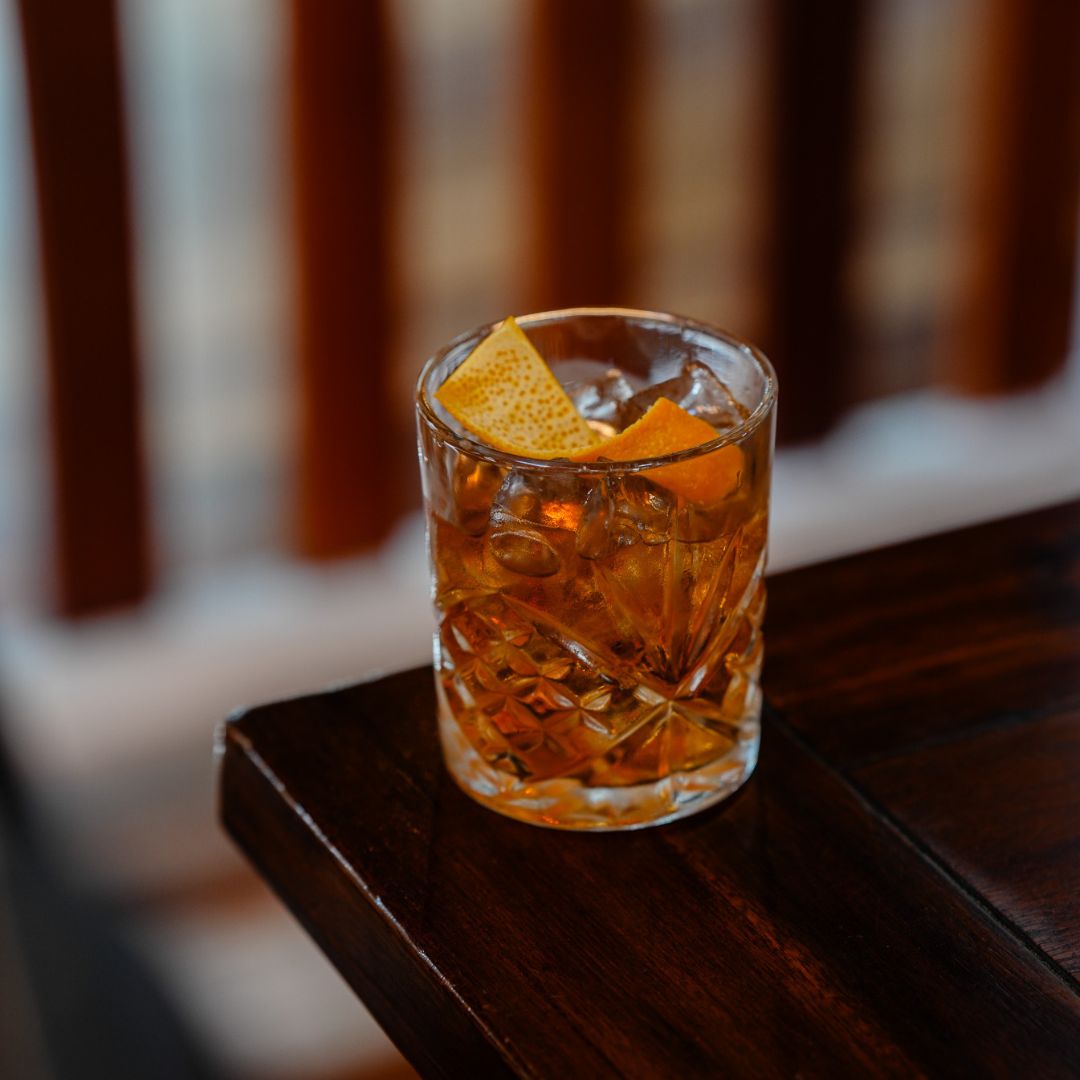 Whisky cocktail made with Tamborine Mountain Distillery Mountain Whisky and Macadamia Liqueur, served in a rocks glass over a large ice cube with orange peel garnish