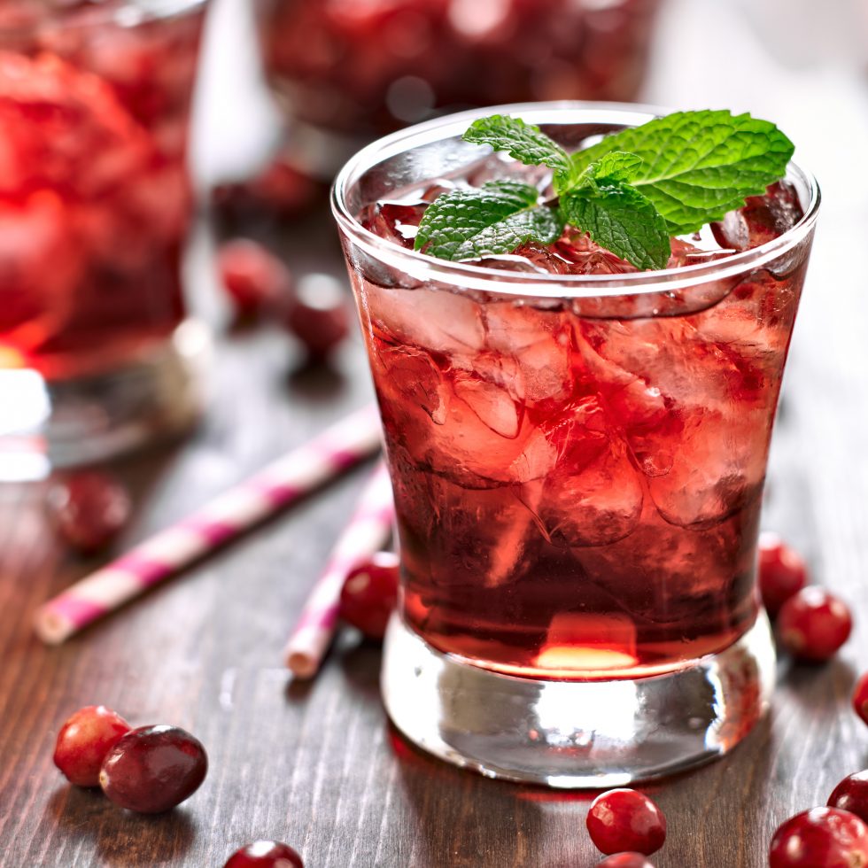 Shumalla cocktail served over ice with Wild Forest Plum, Cherry, and Quandong & Gentian Bitters liqueurs, cranberry juice, and fresh mint garnish.