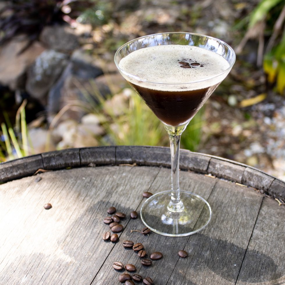 Wattlespresso Martini with Neutral Vodka, Wattle Toffee Liqueur, Caramel Vodka Liqueur, espresso, and simple syrup, garnished with coffee beans in a martini glass.