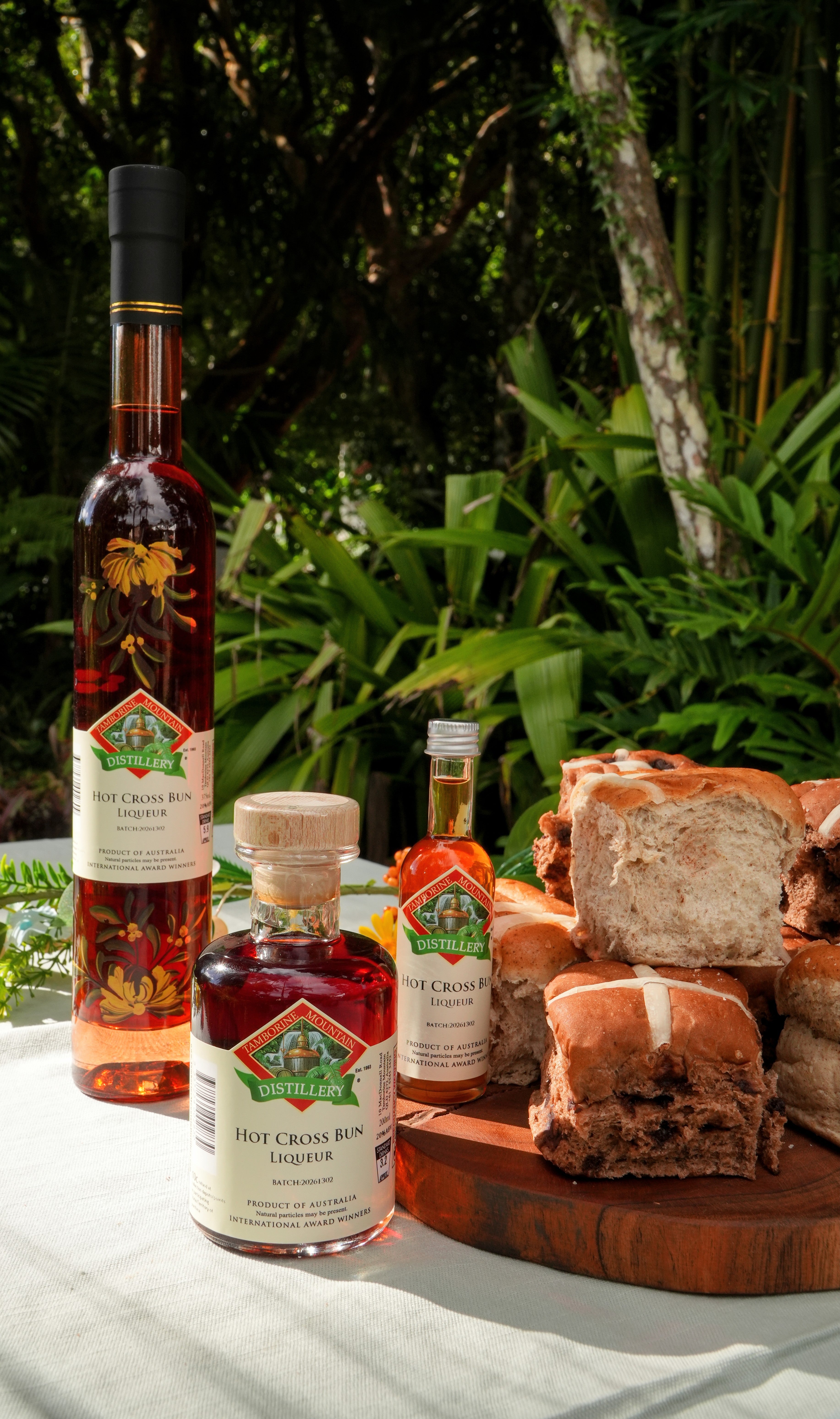 Hot Cross Bun Liqueurs and buns on a table with a natural background