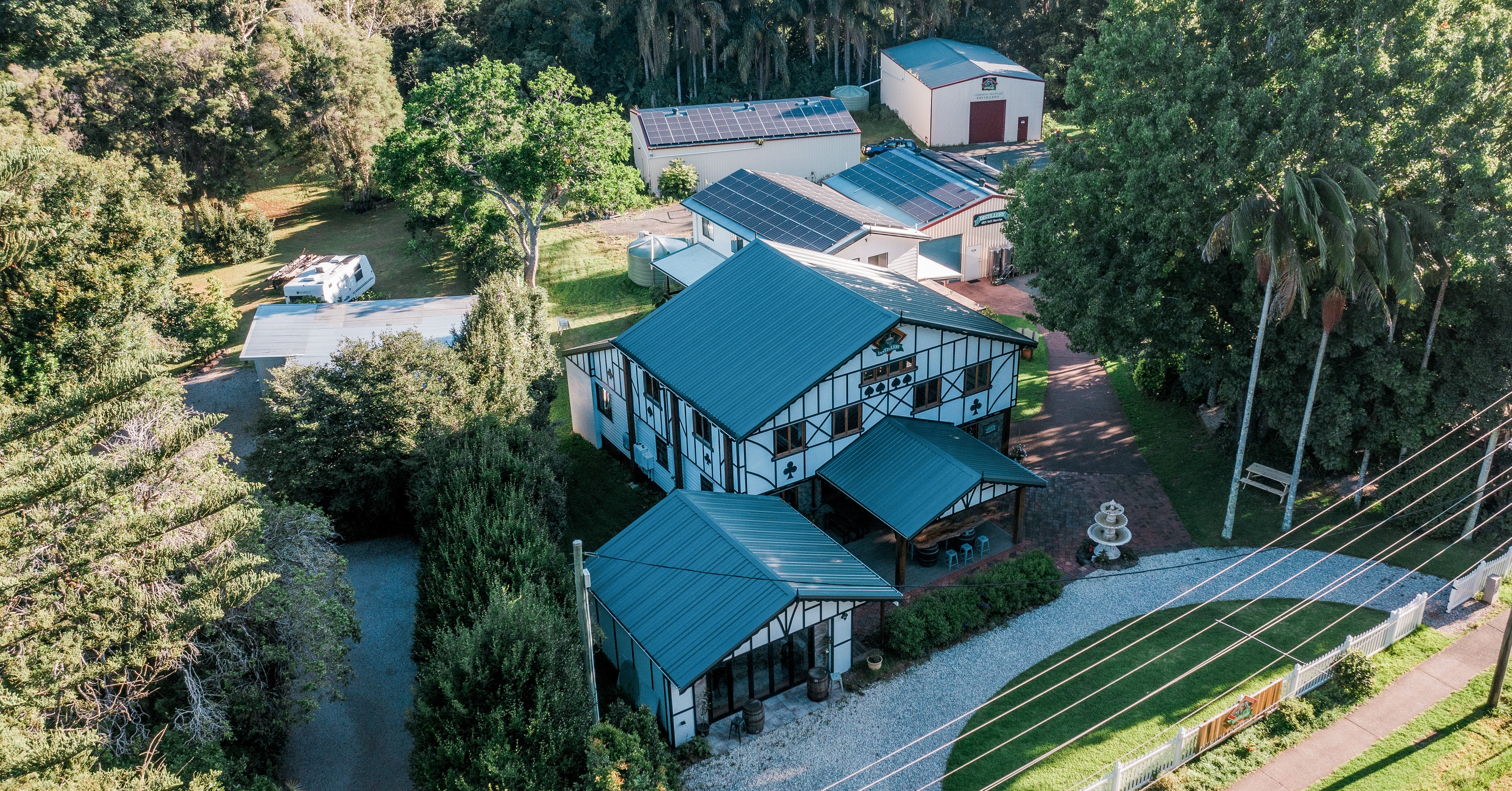 Aerial view of a building surrounded by trees and greenery